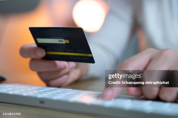 closeup young woman hands holding credit card ,for online shopping or reporting lost card, fraudulent transaction - lies ストックフォトと画像