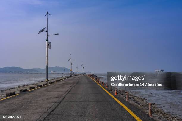 road and mud flat in jebudo island, hwaseong, south korea - yellow sea stock-fotos und bilder