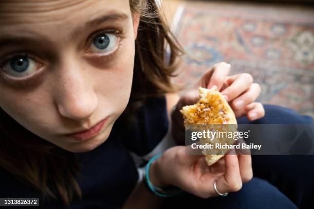 teenage girl eating a crumpet - marmite stock pictures, royalty-free photos & images