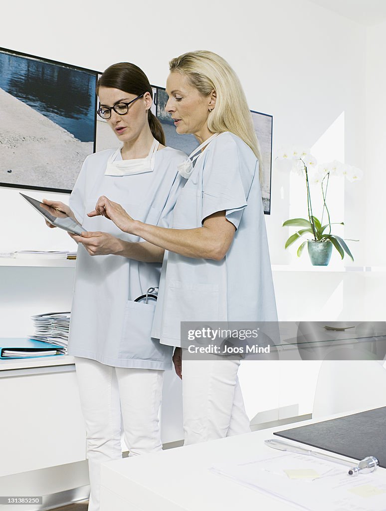 Female doctors using digital tablet