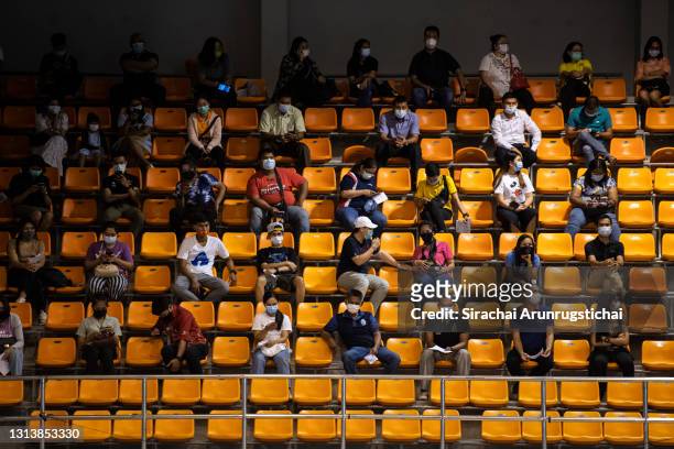 People take seats within a sport stadium while waiting to receive vaccination with the CoronaVac vaccine developed by Sinovac firm on April 22, 2021...