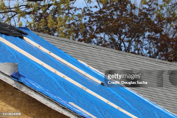 temporary cover on a damaged roof - damaged roof stock pictures, royalty-free photos & images