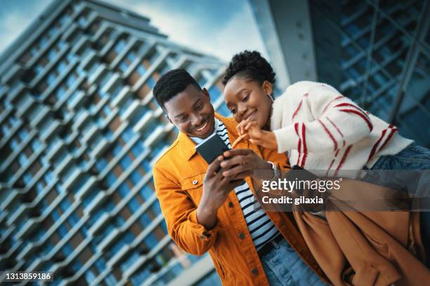 young afro american couple enjoying sunny day and taking selfies. - euforia imagens e fotografias de stock
