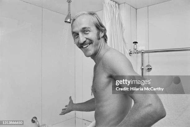 American lawn tennis player Stan Smith smiling as he prepares to take a shower in London, England, 25th June 1973. Smith has boycotted the 1973...