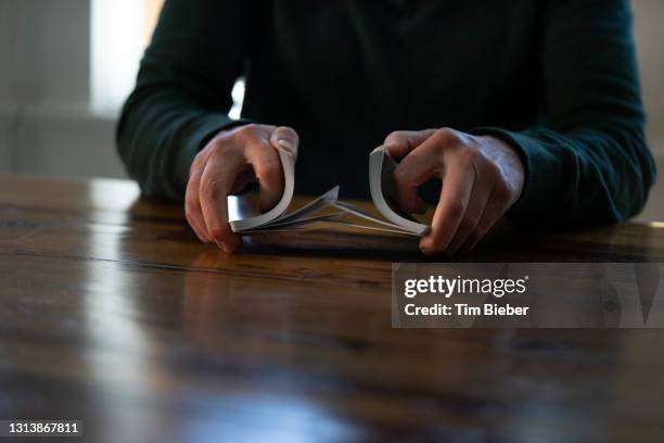 Hands shuffling a deck of playing cards, symbolizing repetitive actions without progress