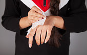 Woman hands being dried with tissue paper.