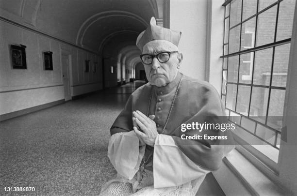 Hungarian Roman Catholic Archbishop Jozsef Mindszenty , his hands held together in prayer, wearing a biretta as he prepares to celebrate mass at...