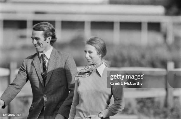 British equestrian Captain Mark Phillips, wearing a tweed blazer, and his fiancee, British Royal Anne, Princess Royal, wearing a ribbed sweater, over...