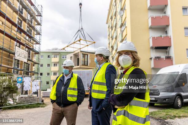 Agriculture and Consumer Protection Minister Julia Kloeckner looks on as she visits an apartment building under construction and made mainly of wood...