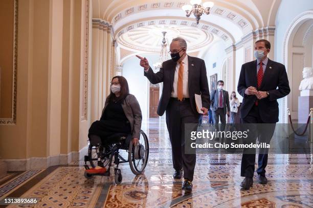 Sen. Tammy Duckworth , Senate Majority Leader Charles Schumer and Sen. Richard Blumenthal walk to a news conference following the passage of the...