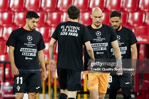 Players of SD Eibar wear protest t-shirts with the words 'Earn it' and 'Soccer is for the fans' prior the La Liga Santander match between Granada CF...