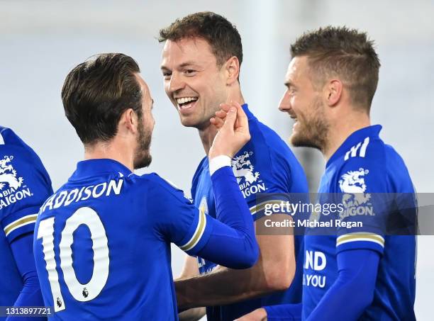 Jonny Evans of Leicester City celebrates after scoring their sides second goal with team mates James Maddison and Jamie Vardy during the Premier...