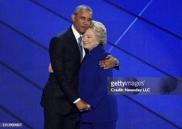President Barack Obama and Hillary Clinton embrace on the stage after the speech by Obama at the Democratic National Convention at the Wells Fargo...