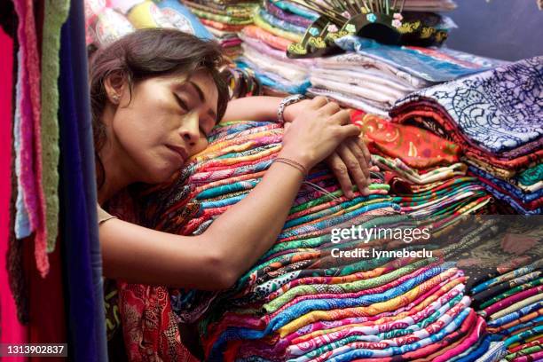 sleeping vendor - ubud market, bali - bali women tradition head stock pictures, royalty-free photos & images
