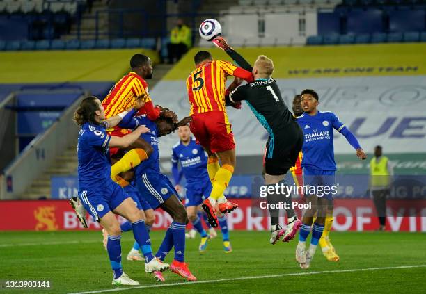 Kasper Schmeichel of Leicester City punches the ball clear whilst under pressure from Kyle Bartley of West Bromwich Albion during the Premier League...