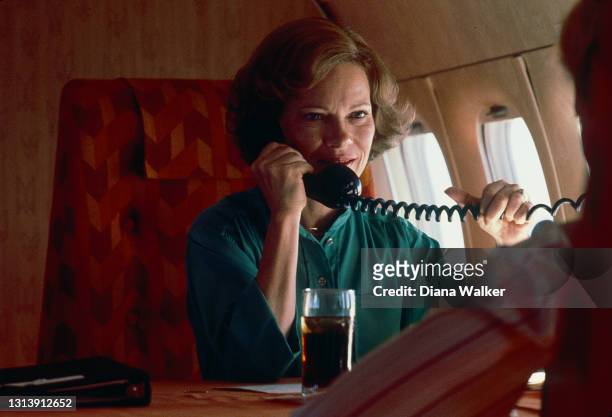First Lady Rosalynn Carter talks on the telephone in her plane as she returns from a campaign trip , October 5, 1979.