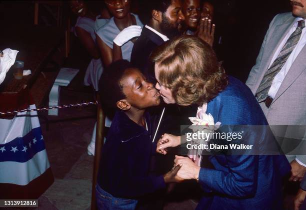 First Lady Rosalynn Carter leans over to kiss an unidentified supporter as she attends the Duval County Democratic Garden Party during her husband's...