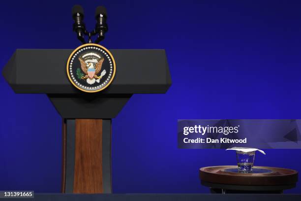 Glass of water sits beside the podium before the President of The United States Barack Obama addresses members of the media during a conference on...