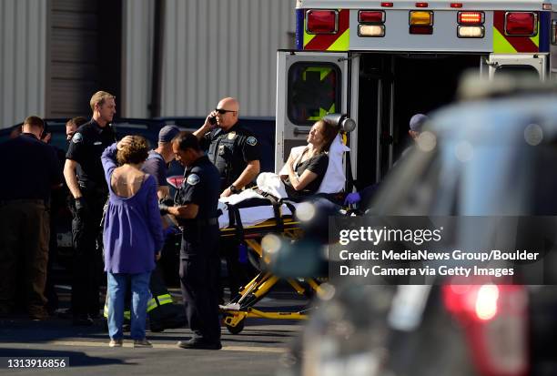 Woman with a gunshot wound is seen on a stretcher as Boulder Police investigate a shooting at Black Lab Sports in Boulder on Oct. 16, 2019. The woman...