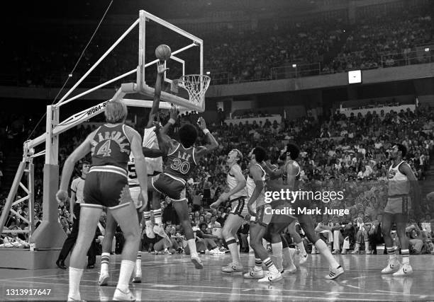 Denver Nuggets forward David Thompson blocks a shot by Phoenix Suns guard Ron Lee during an NBA basketball game at McNichols Arena on October 30,...