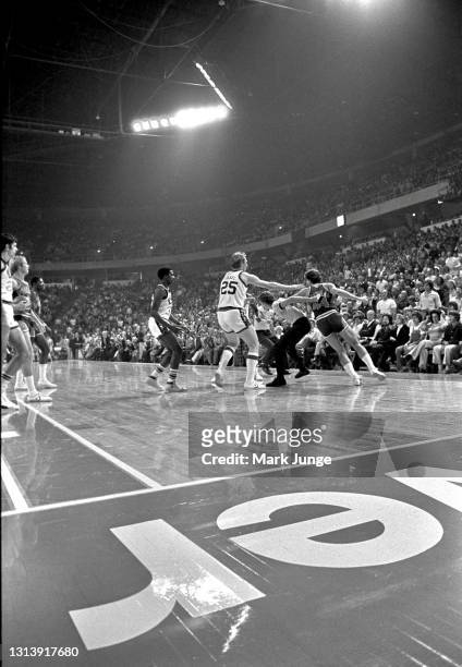 The referees get between players on the court during an NBA basketball game at McNichols Arena on October 30, 1976 in Denver, Colorado. Left to right...