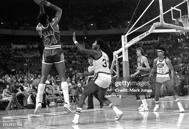 Phoenix Suns forward Gar Heard takes a jump shot over Denver Nuggets forward Paul Silas during an NBA basketball game at McNichols Arena on October...