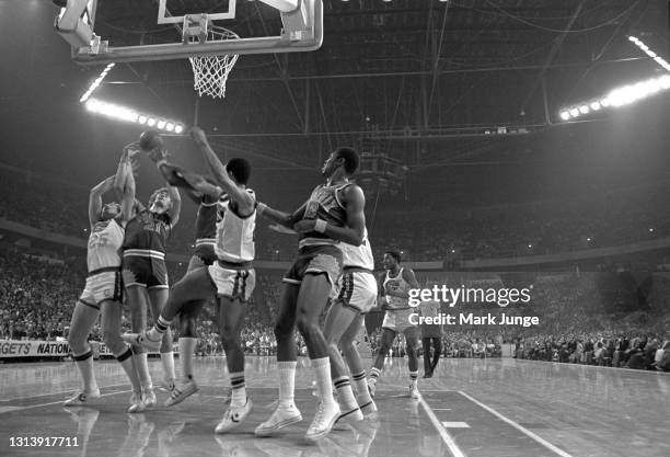 Denver Nuggets center Dan Issel and Phoenix Suns center Dennis Awtrey tie up under the basket during an NBA basketball game at McNichols Arena on...