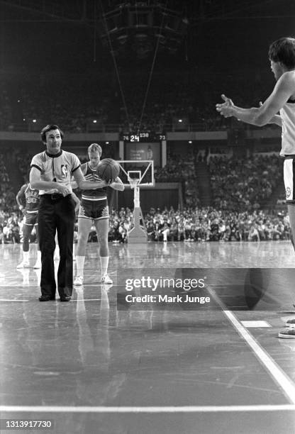 Referee listens to a complaint by Denver Nuggets forward Byron Beck before handing the ball to Dick Van Arsdale standing at the free throw line...