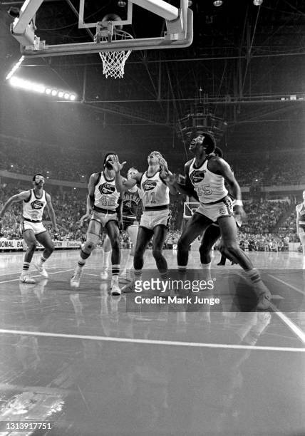 Six players wait under the basket for a rebound during an NBA basketball game between the Denver Nuggets and Phoenix Suns at McNichols Arena on...