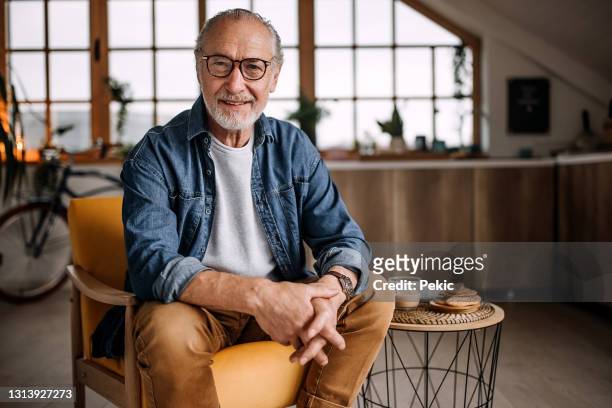 portrait of senior man sitting in chair - white caucasian stock pictures, royalty-free photos & images