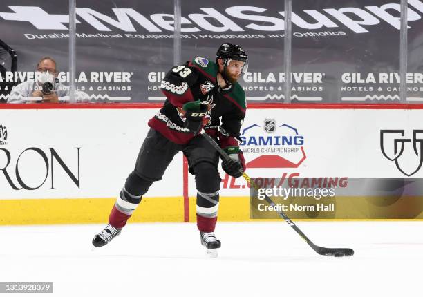 Alex Goligoski of the Arizona Coyotes passes the puck against the Minnesota Wild at Gila River Arena on April 21, 2021 in Glendale, Arizona.