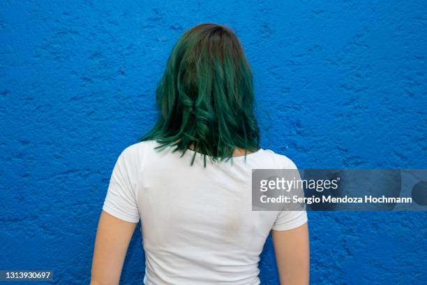 young woman with green hair and back to the camera in mexico city - green hair stock pictures, royalty-free photos & images