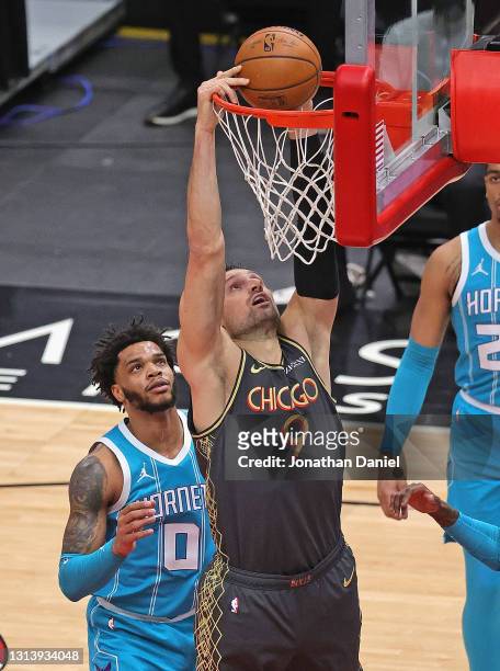 Nikola Vucevic of the Chicago Bulls dunks over Miles Bridges of the Charlotte Hornets at the United Center on April 22, 2021 in Chicago, Illinois....
