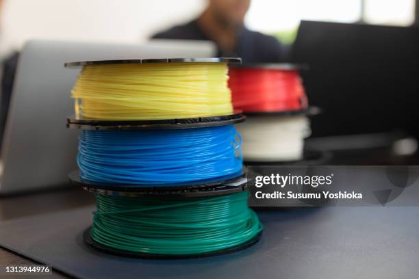 people working in a small business office using a 3d printer. - filamento fotografías e imágenes de stock