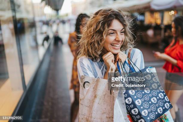 cheerful friends shopping in the city - shopping excitement stock pictures, royalty-free photos & images