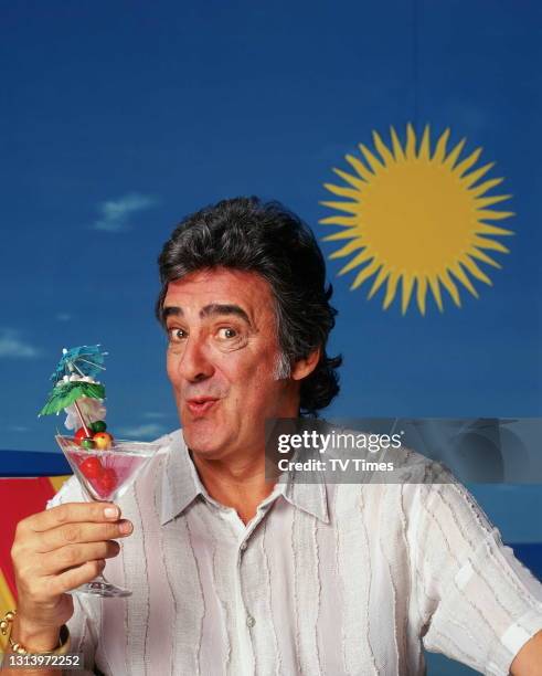 Bargain Hunt presenter David Dickinson photographed on a beach set, circa 2003.