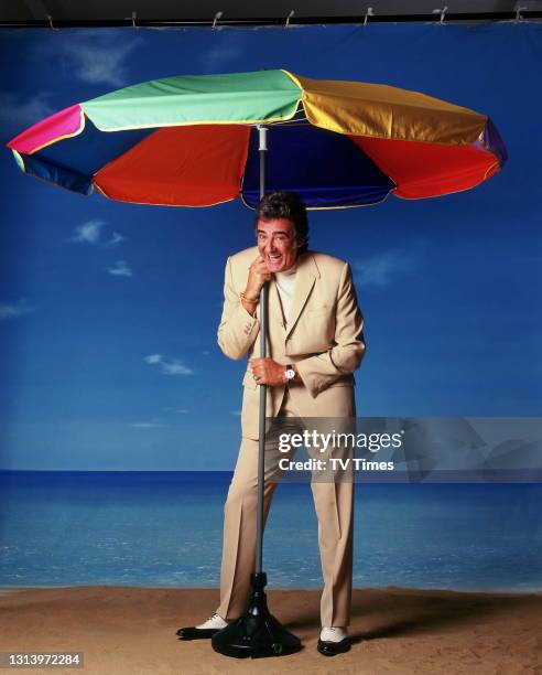 Bargain Hunt presenter David Dickinson photographed on a beach set, circa 2003.