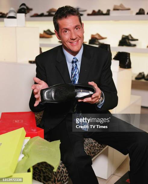 Television presenter Dale Winton in a shoe shop, circa 2003.
