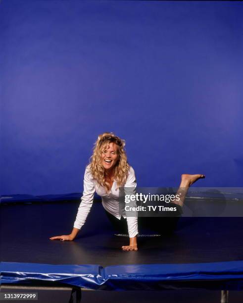 Television presenter Linda Barker jumping on a trampoline, circa 2004.