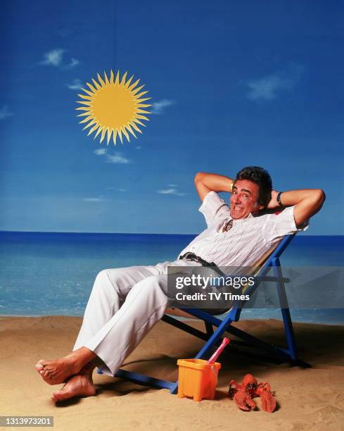 Bargain Hunt presenter David Dickinson photographed on a beach set, circa 2003.