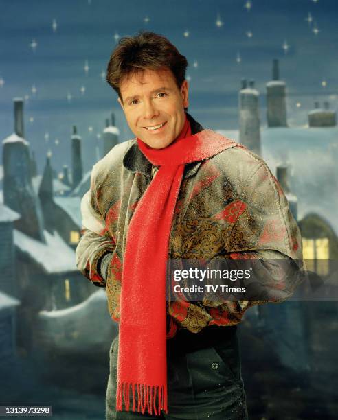 Singer Cliff Richard posed in a snowy Christmas scene, circa December 1990.