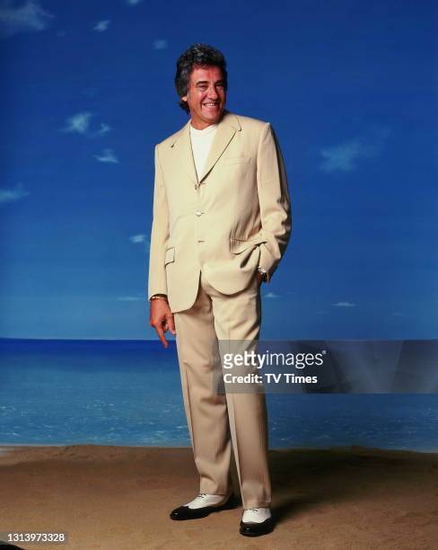 Bargain Hunt presenter David Dickinson photographed on a beach set, circa 2003.