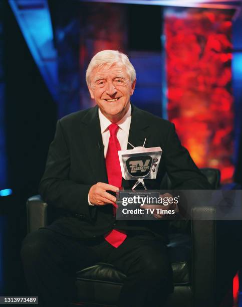 Television presenter Michael Parkinson holding a TV Times award, circa 2006.