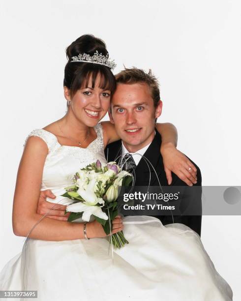 Emmerdale actors Sheree Murphy and Mark Charnock in character as Tricia and Marlon Dingle in their wedding outfits, circa 2002.