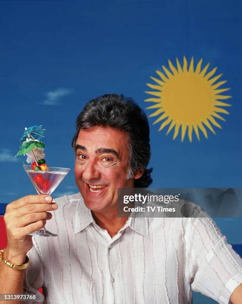 Bargain Hunt presenter David Dickinson photographed on a beach set, circa 2003.