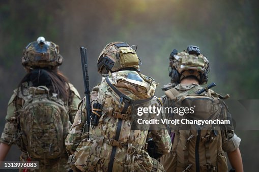 Rear of soldiers patrolling along the risky area. Rear of soldiers patrolling along the risky area.