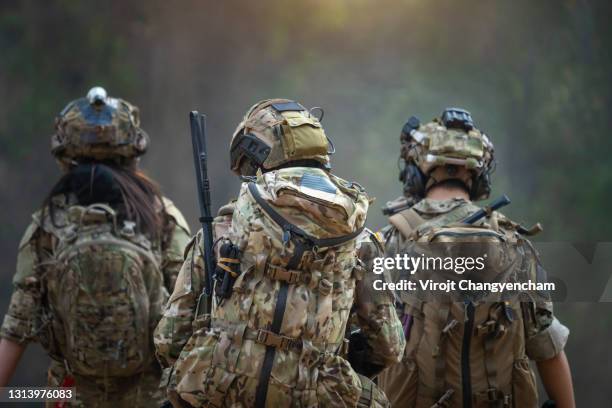 rear of soldiers patrolling along the risky area. - terrorism ストックフォトと画像