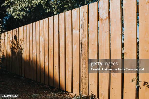 diminishing perspective of fence panels - timber yard stock pictures, royalty-free photos & images