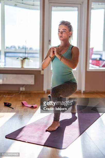 athletic woman exercising in a lunge position at home - prop stock pictures, royalty-free photos & images