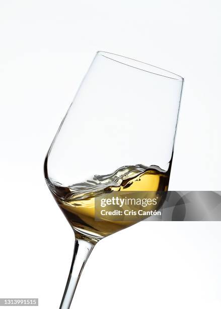 white wine swirling into glass - white wine stockfoto's en -beelden